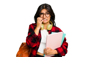 Young student Indian woman wearing headphones isolated biting fingernails, nervous and very anxious.