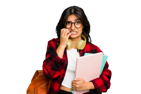 Young student Indian woman wearing headphones isolated biting fingernails, nervous and very anxious.