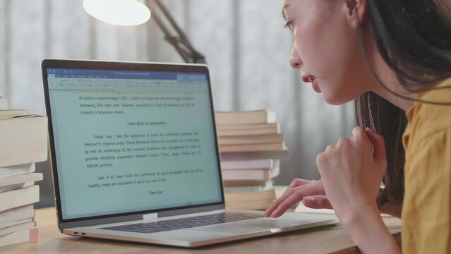 Close Up Of A Young Female Celebrating Finish Reading The Text On A Laptop While Studying At Home
