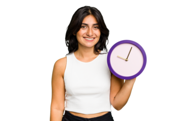 Young Indian woman holding a clock isolated happy, smiling and cheerful.