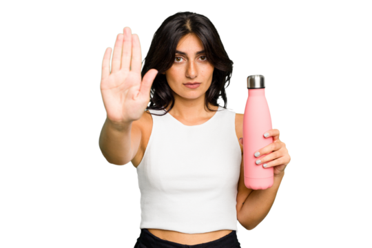 Young Indian woman holding a thermo isolated standing with outstretched hand showing stop sign, preventing you.