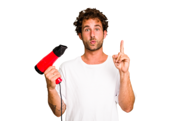 Young caucasian man holding an hairdryer isolated having some great idea, concept of creativity.
