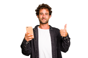 Young caucasian man using mobile phone isolated smiling and raising thumb up