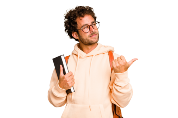 Young caucasian student man isolated points with thumb finger away, laughing and carefree.