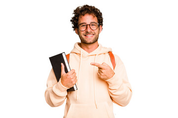 Young caucasian student man isolated smiling and pointing aside, showing something at blank space. - obrazy, fototapety, plakaty