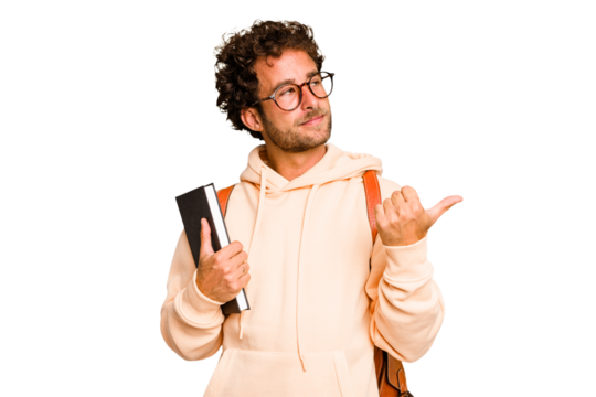 Young caucasian student man isolated points with thumb finger away, laughing and carefree.