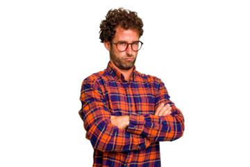 Young caucasian curly hair man isolated Young caucasian man with curly hair isolated frowning face in displeasure, keeps arms folded.