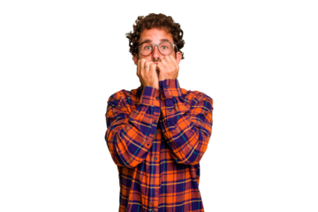 Young caucasian curly hair man isolated Young caucasian man with curly hair isolated biting fingernails, nervous and very anxious.
