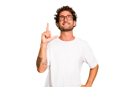 Young caucasian curly hair man isolated Young caucasian man with curly hair isolated indicates with both fore fingers up showing a blank space.