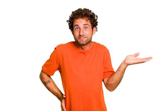 Young caucasian curly hair man isolated Young caucasian man with curly hair isolated showing a copy space on a palm and holding another hand on waist.