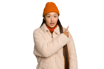 Young asian woman wearing winter clothes isolated on green chroma background pointing to the side