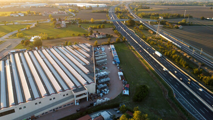 aerial photo highway tollway a1 autostrada del sole in Piacenza Italy at sunset