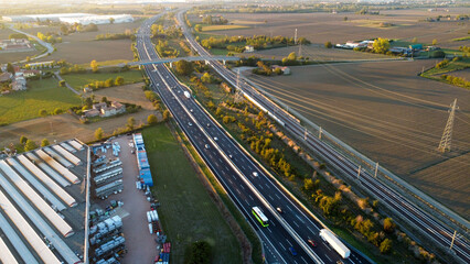 aerial photo highway tollway a1 autostrada del sole in Piacenza Italy at sunset - obrazy, fototapety, plakaty