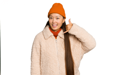Young asian woman wearing winter clothes isolated on green chroma background showing a mobile phone call gesture with fingers.