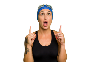 Young caucasian swimmer woman isolated on green chroma background pointing upside with opened mouth.
