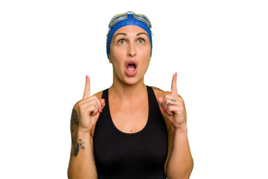 Young caucasian swimmer woman isolated on green chroma background pointing upside with opened mouth.