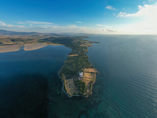 Aerial photography, island on sea with turquoise water and blue cloudy sky