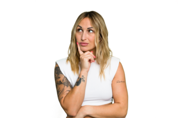 Young caucasian woman isolated on green chroma background contemplating, planning a strategy, thinking about the way of a business.