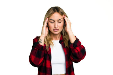 Young caucasian woman isolated on green chroma background having a head ache, touching front of the face.