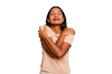 Young Indian woman isolated hugs, smiling carefree and happy.