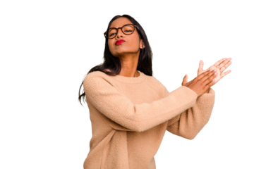 Young Indian woman isolated feeling energetic and comfortable, rubbing hands confident.