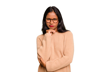 Young Indian woman isolated suspicious, uncertain, examining you.