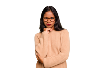 Young Indian woman isolated suspicious, uncertain, examining you.