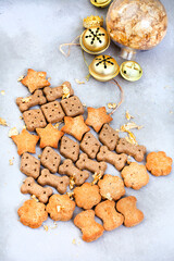 Doggie and pet Christmas gifts for a furrtabulous festive season. Dog treats in Christmas tree shape on mottled grey