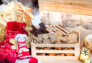 Doggie treat Christmas box in rustic festive setting with jingle bells