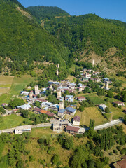 Drone view of the Svan Towers in Mestia on a sunny day, Svaneti region, Georgia. This is a high-altitude town in the north-west of Georgia, at an altitude of 1500 meters in the Caucasus mountains.