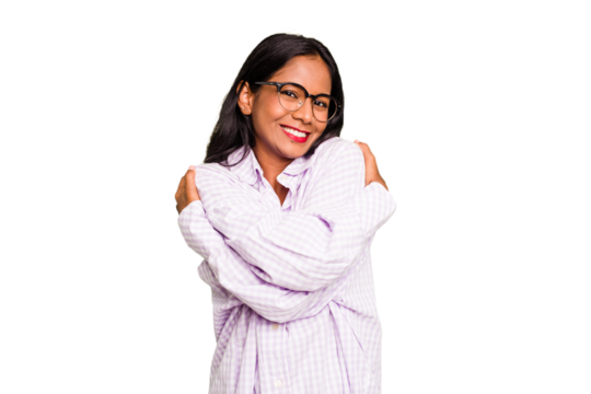 Young Indian woman isolated hugs, smiling carefree and happy.