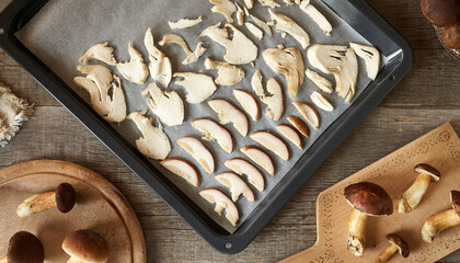 Cutting, slicing and drying wild bolete mushrooms on a table