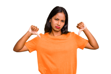 Young Indian woman isolated showing a dislike gesture, thumbs down. Disagreement concept.