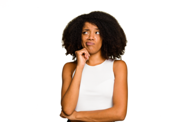 Young African American woman isolated thinking and looking up, being reflective, contemplating, having a fantasy.