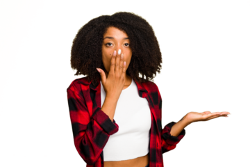 Young African American woman isolated impressed holding copy space on palm.