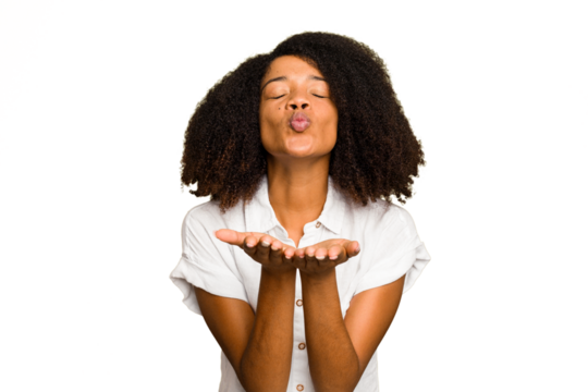 Young African American woman isolated folding lips and holding palms to send air kiss.