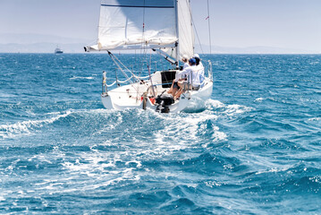 Sailing crew on sailboat during regatta