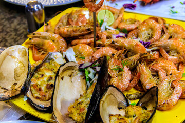 Tasty prawns and mussels in plate in restaurant