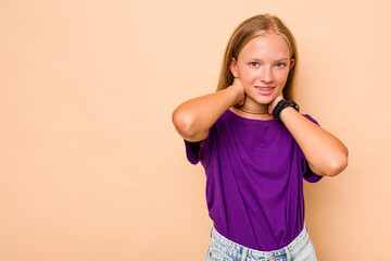 Caucasian teen girl isolated on beige background touching back of head, thinking and making a...