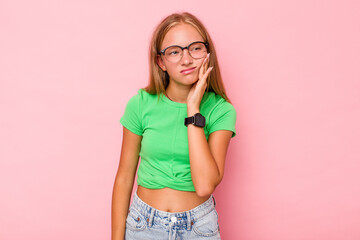 Caucasian teen girl isolated on pink background having a strong teeth pain, molar ache.