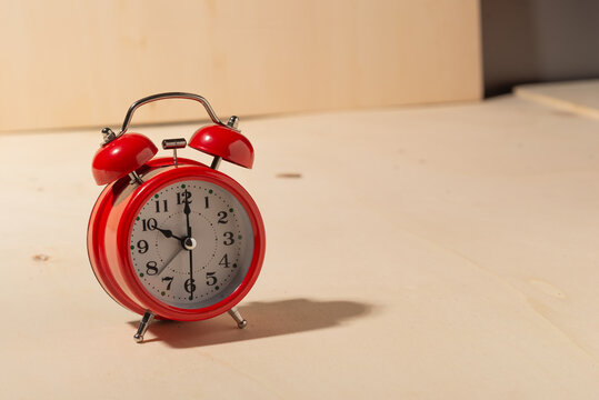 Old Red Clock On Wooden Background
