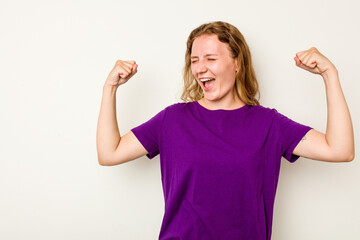 Young caucasian woman isolated on white background raising fist after a victory, winner concept.