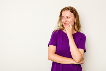 Young caucasian woman isolated on white background relaxed thinking about something looking at a copy space.