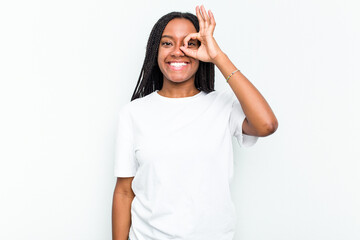 Fototapeta premium Young African American woman isolated on white background excited keeping ok gesture on eye.