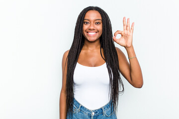 Young African American woman isolated on white background cheerful and confident showing ok gesture.