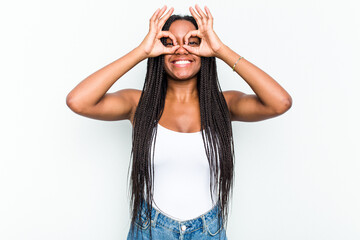 Young African American woman isolated on white background showing okay sign over eyes