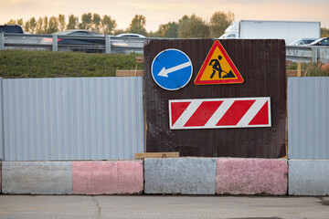 road sign indicating a detour and road works