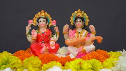 Statue of Indian God Lakshmi and Saraswati. Hindu gods. Holiday banner or greeting card for Indian festival Happy Diwali.
