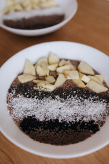 Vegan raw flaxeed porridge with fruits and chia, black sesame and psyllium seeds, coconut flakes. Healthy nutritious and fresh food. Two plates