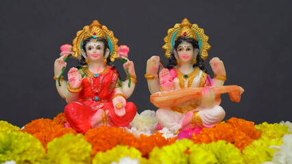 Statue of Indian God Lakshmi and Saraswati. Hindu gods. Holiday banner or greeting card for Indian festival Happy Diwali.